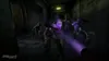 A dark, gritty hallway with several zombie-like figures advancing towards the viewer, illuminated by a purple light emanating from a flashlight. Produktbild-Vorschau