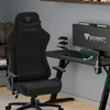 A gaming chair and desk setup in a room. Produktbild-Vorschau