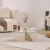 A modern living room scene featuring a travertine coffee table with a glass top, a sofa, a rug, and decorative items. Anteprima dell’immagine prodotto