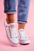 A person wearing white Big Star sneakers and blue jeans, standing against a pink background. Voir les images du produit