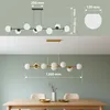 A product image showing a chandelier with dimensions and a lifestyle shot of the same chandelier hanging over a dining table. Náhľad obrázku produktu