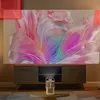 A projector is set up in a living room, projecting an image onto a large screen above a media console. Produktbild-Vorschau