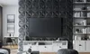A modern living room with a large TV mounted on a textured wall, a white media console, and a bookshelf. Produktbild-Vorschau