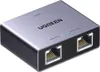 A Ugreen Ethernet Splitter Adapter Nw301 (1X2) is shown from a slightly elevated front-diagonal angle against a light gray background. Produktbild-Vorschau