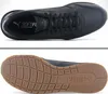 A top-down view and a bottom view of a black Puma sneaker. Voir les images du produit