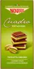 A box of Novi Cuadro Pistachio chocolates, with a stack of chocolates and pistachios shown. Produktbild-Vorschau