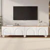 A modern TV stand with a wooden top and white cabinet doors, featuring arched designs and round legs, placed in a living room setting with a TV mounted on the wall above it. Anteprima dell’immagine prodotto