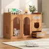 A wooden cat cabinet with a cat inside, placed on a rug in a well-lit room. Produktbild-Vorschau