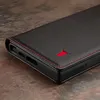 A close-up shot of a black leather phone case with red stitching and a red logo. Anteprima dell’immagine prodotto
