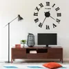 A living room scene with a large wall clock, a TV stand, a television, a floor lamp, and a rug. Náhled obrázku produktu