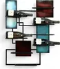 A modern metal wine rack holding several bottles of wine, mounted on a white wall. Náhled obrázku produktu