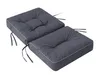 Two dark grey cushions with white piping and ties, placed side-by-side on a white background. Náhled obrázku produktu