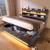 A modern upholstered bed with storage and LED lighting, shown in a bedroom setting at night. Produktbild-Vorschau