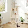A tall, multi-level cat tree with several platforms, a hammock, and two enclosed spaces, situated in a room with a window and a dresser. Three cats are visible on or interacting with the cat tree. Anteprima dell’immagine prodotto