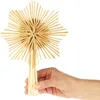 A hand holding a straw star Christmas tree topper against a white background. Produktbild-Vorschau