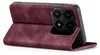 A close-up side view of a burgundy flip phone case for a smartphone, with the phone partially inserted. Produktbild-Vorschau