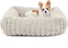 A small dog is lying in a plush dog bed. Produktbild-Vorschau