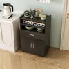 A kitchen cart with various kitchen items on it, placed next to a counter. Náhled obrázku produktu