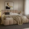 A bedroom scene featuring a bed with bedding and a piece of art above it. Produktbild-Vorschau