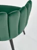 A close-up view of the back and side of a dark green velvet chair with black legs. Náhled obrázku produktu