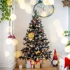A decorated Christmas tree with presents underneath, in a room with a clock on the wall and a plant. Náhled obrázku produktu