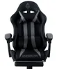 A black and gray gaming chair with a footrest.