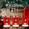 Christmas-themed chair covers are displayed on chairs in a kitchen setting. Produktbild-Vorschau