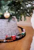 A toy train set circling a Christmas tree. Podgląd zdjęcia produktu