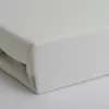 A close-up, angled view of a folded white fitted sheet. Produktbild-Vorschau