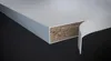 A close-up view of the edge of a white shelf or board, revealing its layered construction. Produktbild-Vorschau