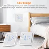 Two smart thermostats are placed on the floor in front of a bed, with another thermostat mounted on the wall. Náhľad obrázku produktu