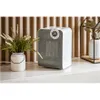 A white electric heater with a digital display sits on a white shelf in front of a slatted wooden wall. A white vase with green foliage is to the left of the heater. Voir les images du produit