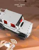 A remote-controlled toy car in a desert-like environment, with a hand holding the remote. Anteprima dell’immagine prodotto