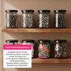 Jars filled with various items like screws, safety pins, and hair clips are displayed on wooden shelves. Produktbild-Vorschau