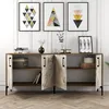 A sideboard with decorative items and artwork displayed above it, set against a white paneled wall. Podgląd zdjęcia produktu