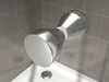 A chrome shower head is mounted on a tiled wall above a white shower tray. Produktbild-Vorschau