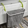 A towel drying rack is attached to a radiator, with towels hanging on it. Produktbild-Vorschau
