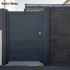 A dark gray gate with a gold knob is shown next to a dark wooden fence. Produktbild-Vorschau