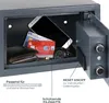 An open safe with various items inside, including a smartphone, credit cards, a wallet, and a watch. Text overlays describe features and compatibility. Produktbild-Vorschau