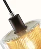 Close-up view of the top of a pendant light fixture, showing the connection point of the cable to the lamp holder and the glass shade with a perforated metal insert. Produktbild-Vorschau