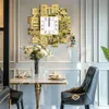 A dining area with a table, chairs, and a decorative wall clock. Voir les images du produit