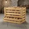 A wooden crate filled with potatoes, placed on a stone floor in what appears to be a cellar or storage area. Podgląd zdjęcia produktu