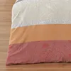 A close-up view of a striped duvet cover with a paisley pattern. Produktbild-Vorschau