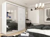 A bedroom scene with a large white wardrobe with mirrored doors, a bed with dark bedding, and decorative elements. Produktbild-Vorschau