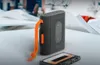 A portable cassette player with an orange lanyard and a cassette tape are placed on a white surface. Voir les images du produit