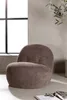 A brown accent chair is placed in a room with a large window and a plant. Podgląd zdjęcia produktu