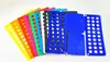A collection of colorful plastic clothing folding boards fanned out on a white background. Náhled obrázku produktu