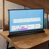 A portable projector screen is set up on a wooden table in a modern office or home setting. Náhľad obrázku produktu