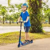 A young boy is riding a blue scooter on a paved path next to a body of water and trees. Náhľad obrázku produktu