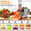 A kitchen counter scene showing a food processor with various vegetables and shredded carrots. Produktbild-Vorschau